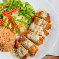 Chiles Poblanos · Two whole breaded chiles poblanos filled with oaxaca cheese, topped with ranchero sauce, ser...