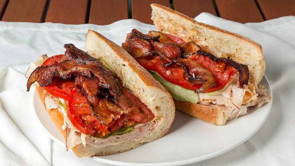 Turkey Club · Applewood Cured Bacon,  All Natural Turkey Breast, Lettuce, Tomato and Garlic Peppercorn Mayonnaise.