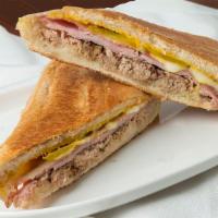 Authentic Cuban Sandwich · Homemade Mojo marinated Pork roasted and pulled, Baked Ham, Genoa Salami, Dill Pickle, Musta...