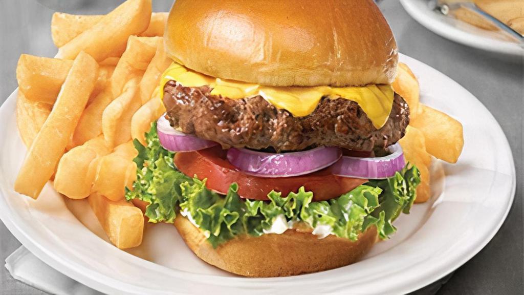 Cheese Burger & Fries · Slices of Kraft American cheese melted on top of a fresh patty grilled to perfection and placed on a soft, toasted sesame seed bun. Served with lettuce onions and tomato. [980 calories]