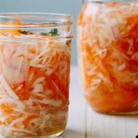 Pikliz Jar (8 Oz) · Haitian cuisine of pickled cabbage, carrots, bell peppers and Scotch bonnet peppers.