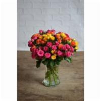 Blooming Sprays · An array of colorful spray roses are arranged in a glass gathering vase. Occasional substitu...