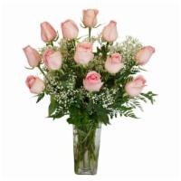 One Dozen Deluxe Pink Roses · One dozen deluxe pink roses, along with seasonal foliage, are designed in a tall oblong vase...