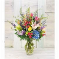 Julia  · A lavish and looser display of the season's finest and freshest floral offerings sees hydran...