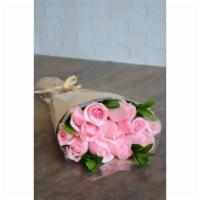Wrapped Roses In Pink · A wrap of powder pink roses, adorned with seasonal filler. Wrapped in craft paper and presen...