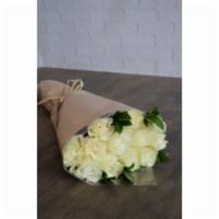 Wrapped Roses In White · A dozen classic white roses, presented along with seasonal greens. Wrapped in craft paper an...