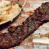 Argentinian Certified Angus Churrasco · Grilled skirt steak with mashed potatoes and chimichurri.