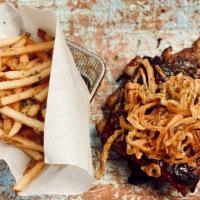 Dolores Baby Back Ribs · St. louis style ribs so tender they fall off the bone with shoestring fries on side and a pa...