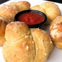 Garlic Knots / Garlic Rolls · Bread knots tossed in garlic, parmesan, and olive oil. Good to pair with pizza!