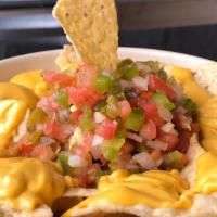 Munchies Loaded Nachos · Restaurant-style tortilla chips topped with warm nacho cheese, onions, fresh tomatoes, jalap...