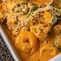 Pescado A Lo Macho · Cheesy seafood sauce over-battered white fish served with rice.