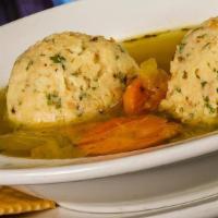 Matzo Ball Soup · Our light and fluffy matzo balls in a rich chicken broth with carrots and onions.
