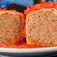 Stuffed Cabbage · Stuffed with seasoned ground beef and rice, topped with sweet and sour sauce.