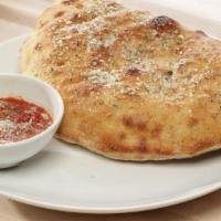 Steak And Cheese Calzone · Tender sliced steak cooked with onions, mushrooms, green peppers & seasoned ricotta cheese.