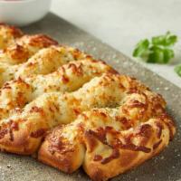 Asiago Cheese Bread (Half) · Fresh baked artisan pull-apart bread topped with Asiago and Romano, served with marinara sau...