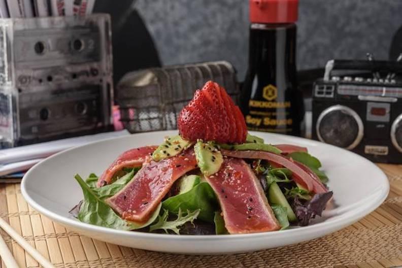 Ahi Tuna Salad · Open wide and say AHI. Just-seared tuna slices, cucumber, avocado and strawberries piled on spring greens, topped with sweet chili, ponzu and sesame seeds.