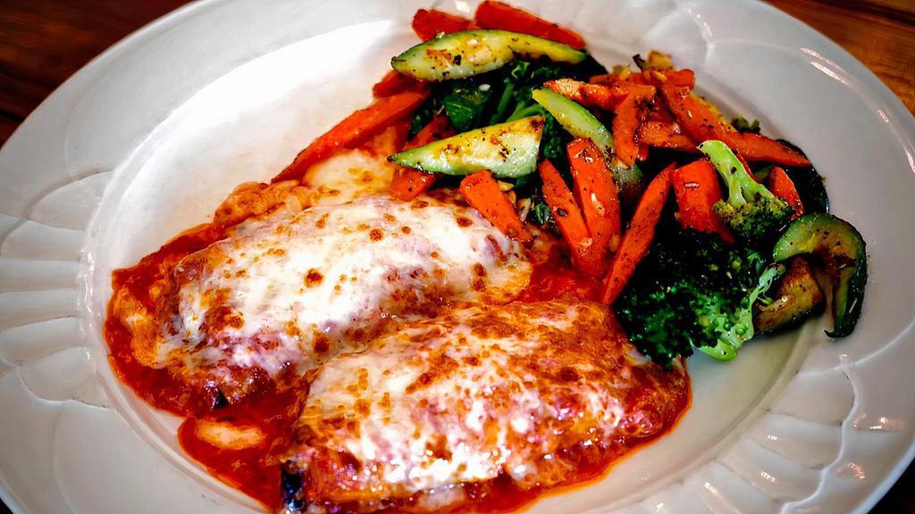 Chicken Parmigiana · Chicken Breast that has been tenderized & hand breaded, topped with marinara & fresh mozzarella served with your choice of spaghetti or sautéed vegetables