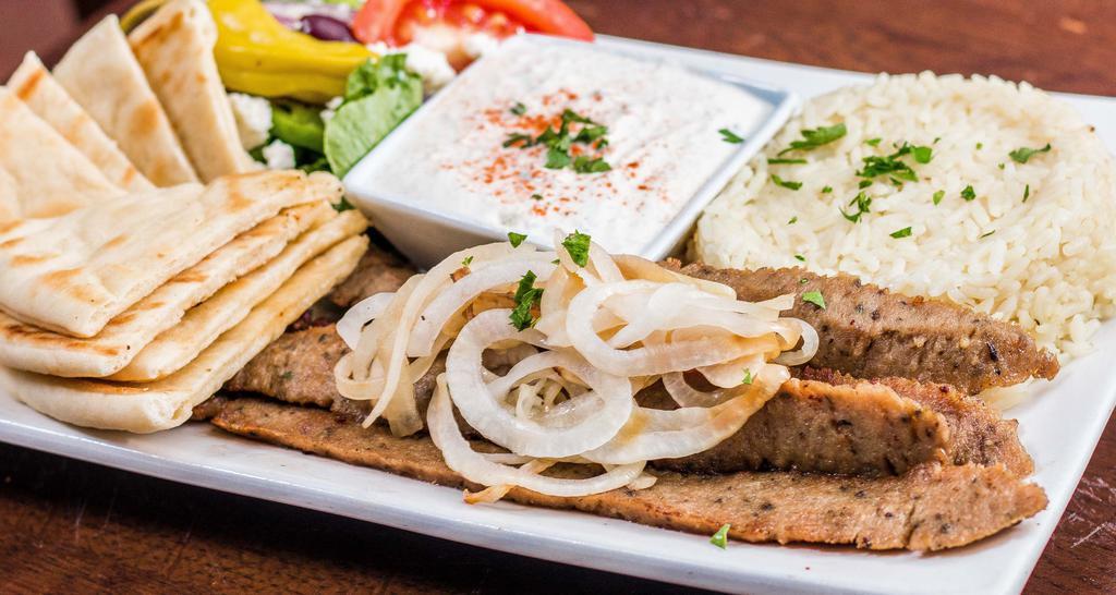 Gyro Plaka · Served with  Greek rice, caramelized onion, pita bread, tzatziki sauce, and Greek salad.