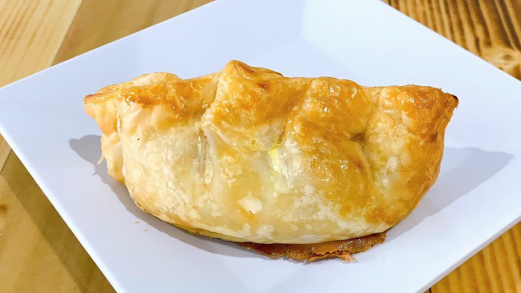 Chicken Empanada · Golden brown, dough pastry with shredded chicken and Argentinian spices.