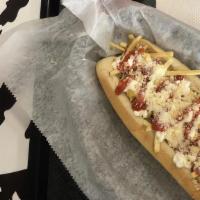 Callejero · Bread, mozzarella cheese, chopped bacon, sausage, potato sticks, pink sauce, green sauce and...