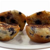 2 Blueberry Muffins · Two large muffins filled with blueberries, sliced in half and grilled to a golden-brown perf...