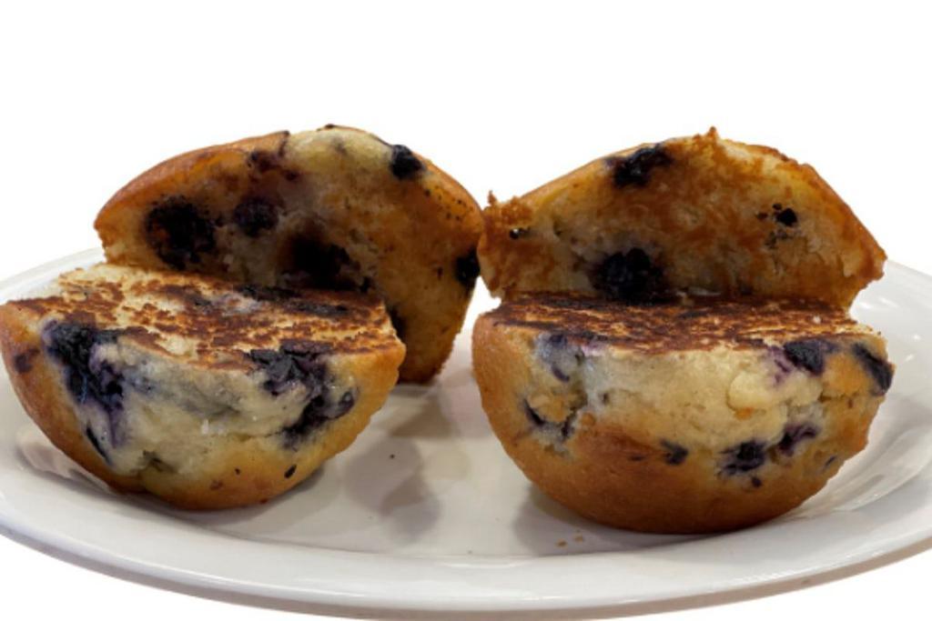 2 Blueberry Muffins · Two large muffins filled with blueberries, sliced in half and grilled to a golden-brown perfection.