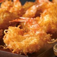 Gold Coast Coconut Shrimp · Hand-dipped in batter, rolled in coconut and fried golden. Paired with Creole marmalade.