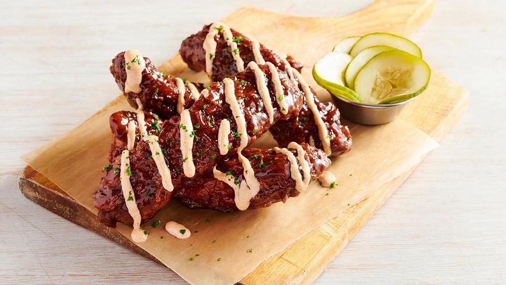 Aussie Twisted Ribs · Our tender Ribs fried Outback-style
then tossed in tangy BBQ sauce and drizzled with
our spicy signature bloom sauce. Garnished with
spicy house-made pickles