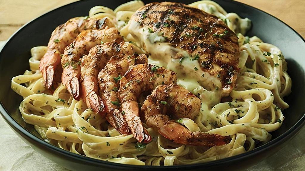 Queensland Chicken & Shrimp Pasta · Fettuccine noodles tossed in a creamy Parmesan cheese sauce with grilled Chicken & Shrimp.