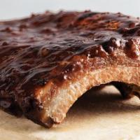 Outback Ribs · Smoked, grilled and brushed with a tangy BBQ sauce. Served with two freshly made sides.