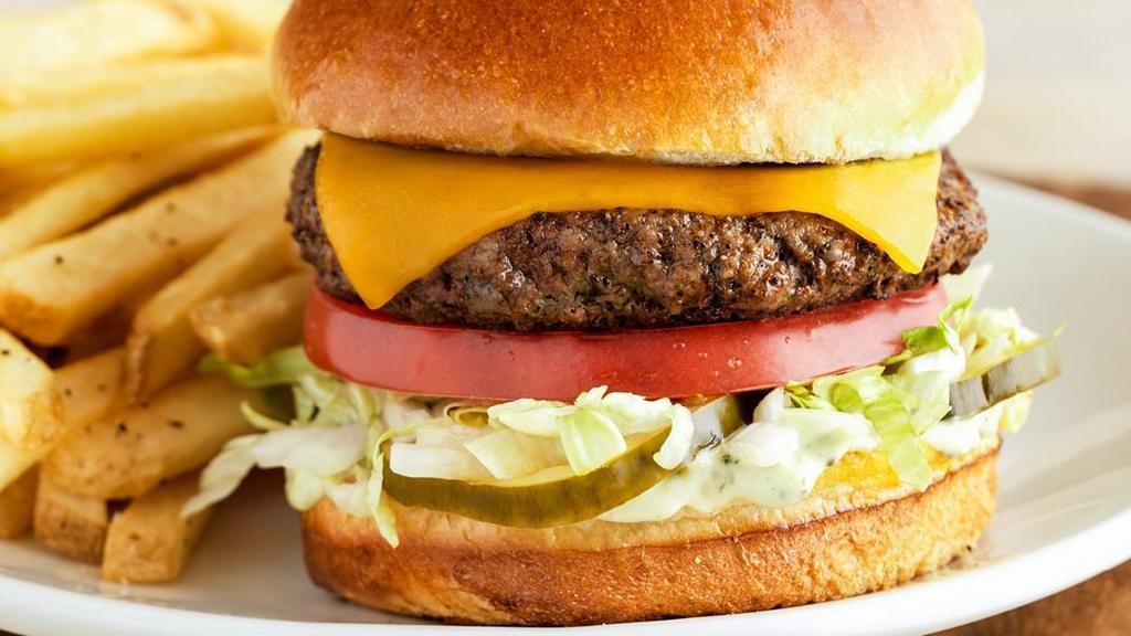 The Outback Burger* · Topped with lettuce, tomato, onion, house-made pickles and mustard. Served with one freshly made side.