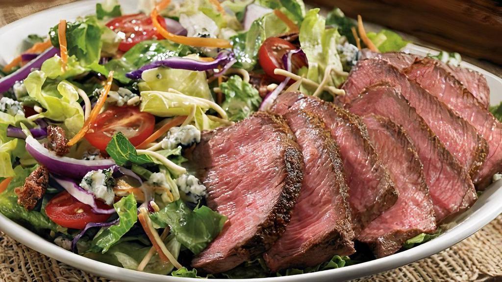 Steakhouse Salad · Seared center-cut sirloin, mixed greens, Aussie Crunch, tomatoes, red onions, cinnamon pecans, green onions, blue cheese crumbles and our Danish Blue Cheese vinaigrette.