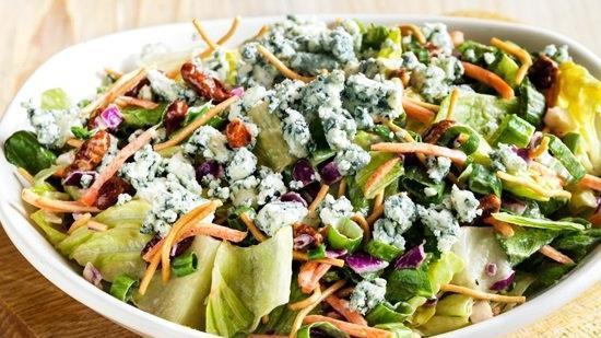Blue Cheese Pecan Chopped Salad · Chopped style mixed greens with shredded carrots, red cabbage, green onions, cinnamon pecans and Aussie Crunch all tossed with Blue Cheese vinaigrette and topped with Blue Cheese crumbles.