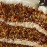 Triple-Layer Carrot Cake · Moist layers of carrot cake with coconut and pecans topped with a sweet vanilla cream cheese...