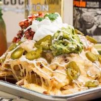 Famous Ultimate Nachos · oaxaca, manchego and cotija cheese, pickled jalapeños, refried beans, pico de gallo, guacamo...