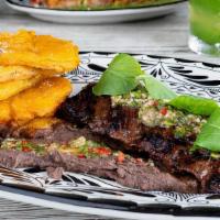 Skirt Steak · fire-grilled skirt steak, chile de arbol chimichurri, refried black beans, crispy tostones