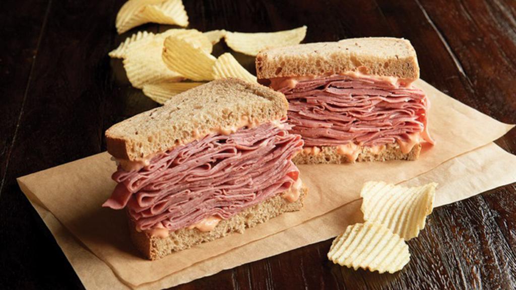Hot Corned Beef Sandwich Regular · 1/2 pound of hot corned beef. Your choice of bread, topped the way you like it. Also served with chips or baked chips (150/100 cal) and a pickle (5 cal). Click Customize to select your sandwich toppings.