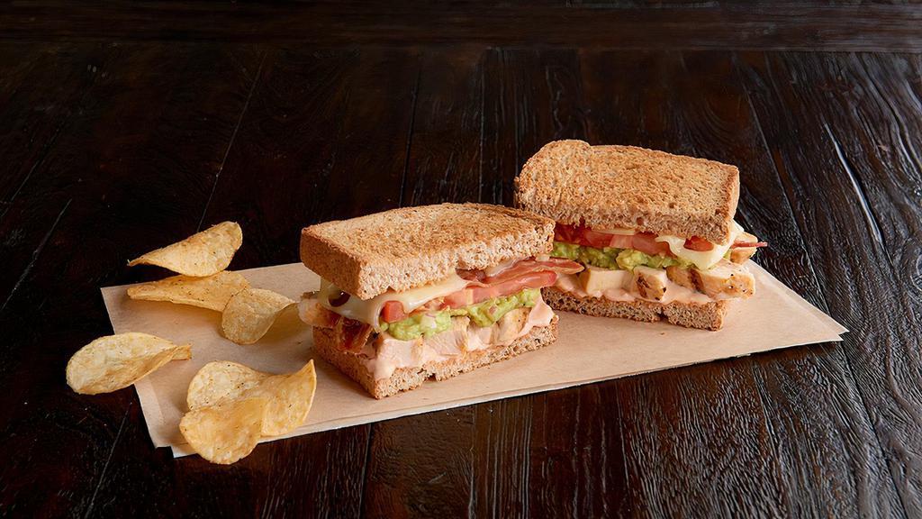 Santa Fe Chicken Sandwich Regular · Grilled, 100% antibiotic-free chicken breast, bacon, Swiss, guacamole, tomato, 1000 Island dressing, on toasted multigrain wheat. Served with chips or baked chips (150/100 cal) and a pickle (5 cal).
