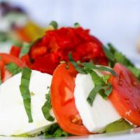 Caprese Salad · Fresh mozzarella, roasted peppers, tomatoes, olive oil, and basil.