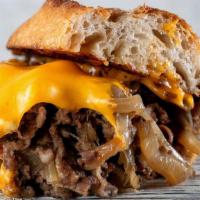 Classic Philly Cheesesteak · shaved rib eye, American cheese, caramelized onions, and Italian roll.