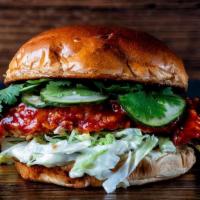 Korean Fried Chicken · sweet and spicy chili sauce, shredded lettuce, pickled cucumbers, green onion lime mayo, fre...