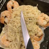 Shrimp Scampi · Shrimp in a white wine garlic butter sauce with parmesan over capellini