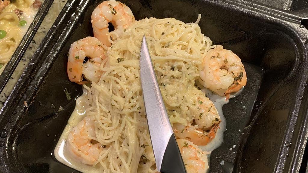 Shrimp Scampi · Shrimp in a white wine garlic butter sauce with parmesan over capellini