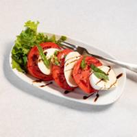 Caprese Salad · Vine ripe tomatoes, fresh mozzarella, basil, EVOO, balsamic glaze