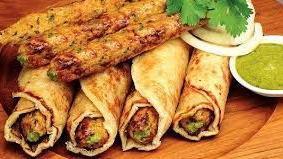 Lamb Kebab Roll · Lamb Seekh kebab wrapped in plain flatbread with onion, cilantro, and spices.