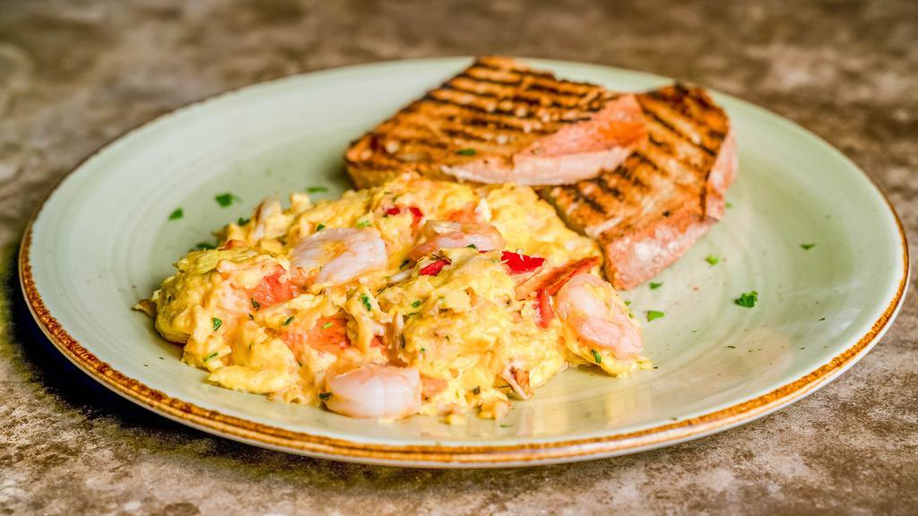 Seafood Scramble · Scrambled eggs, gulf shrimp, blue crab, lobster, fine herbs, and grilled sourdough.