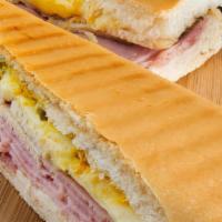 Combo De Sándwich De Desayuno / Breakfast Sandwich Combo · Pan Cubano o croissant relleno con jamón, queso y huevo. / Cuban bread or croissant stuffed ...