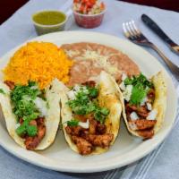 Tacos Al Pastor · Specially marinated pork loin grilled with pineapples and topped with Cilantro and onions. R...