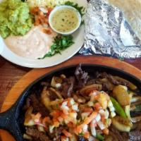 Tm Fajitas · Chicken our  steak grilled with green peppers, onion, and pico de gallo on top. Served with ...