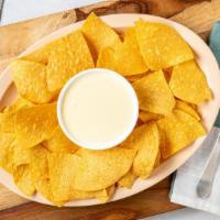 Queso Dip · Comes with a bag of chips.